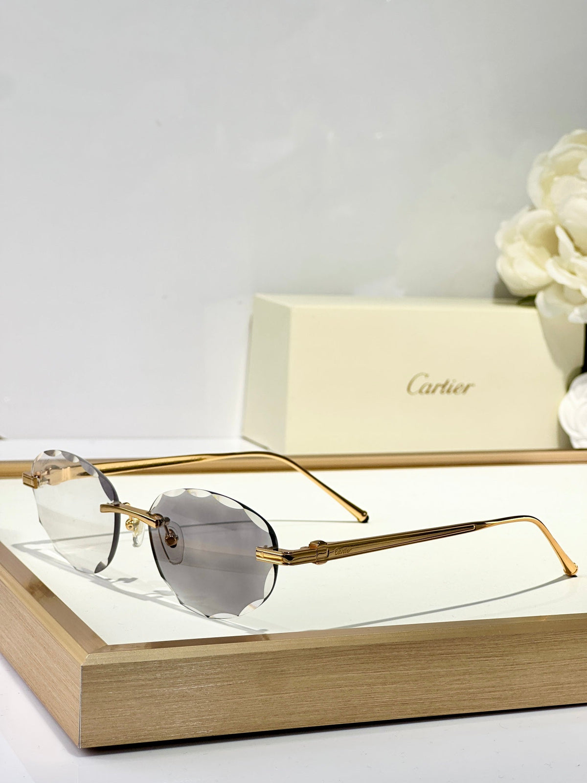 CARTIER C DE RIMLESS ROUND FRAME SUNGLASSES CT0611S IN METAL